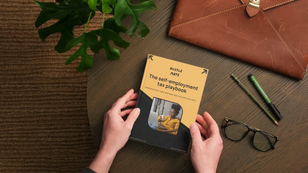 Hands holding a book from Hustle Mate titled: The self employment tax playbook